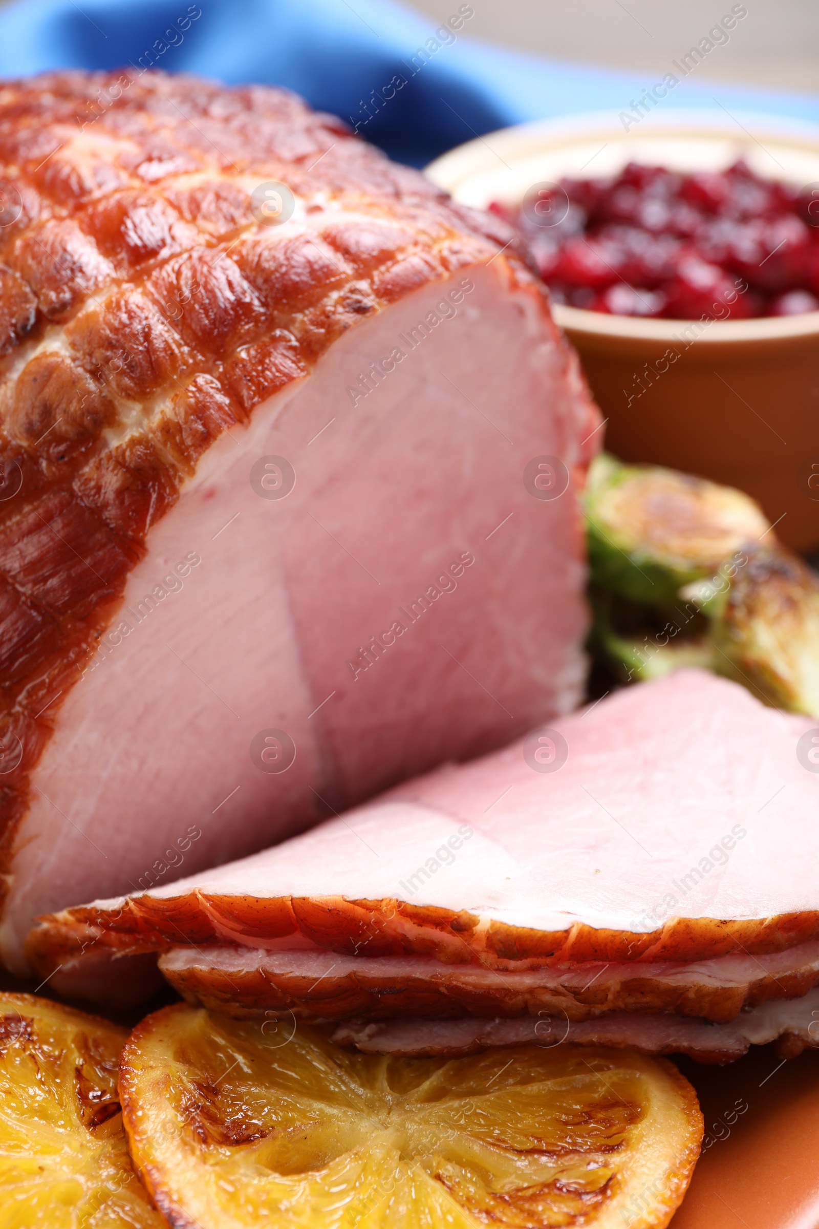 Photo of Christmas food. Tasty baked ham served on table, closeup