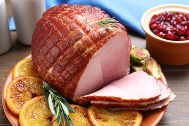 Christmas food. Tasty baked ham served on wooden table, closeup