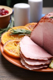 Photo of Christmas food. Tasty baked ham served on wooden table, closeup