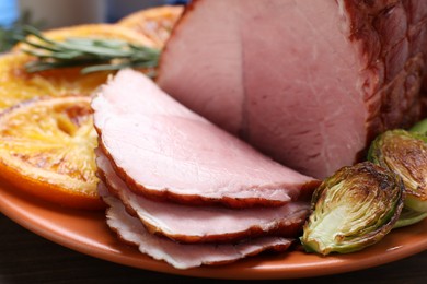 Christmas food. Tasty baked ham served on wooden table, closeup