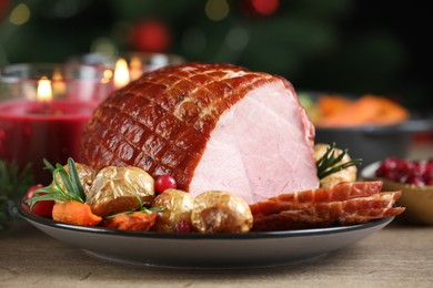 Photo of Christmas food. Tasty baked ham served on wooden table, closeup