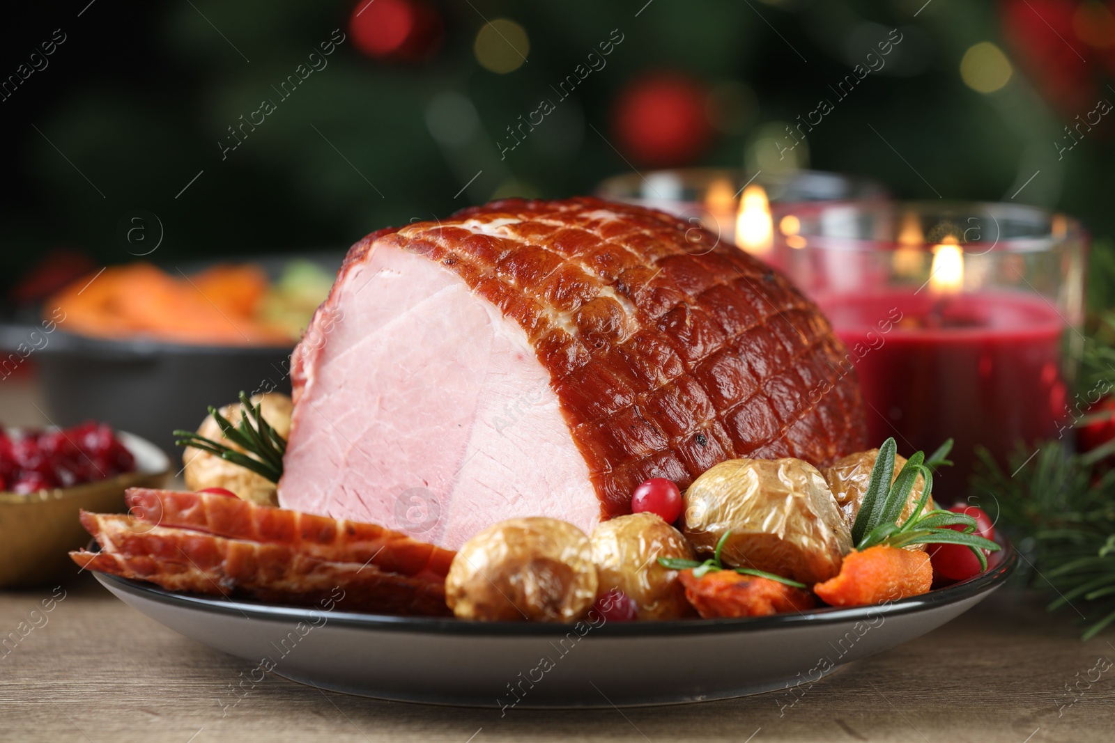 Photo of Christmas food. Tasty baked ham served on wooden table, closeup