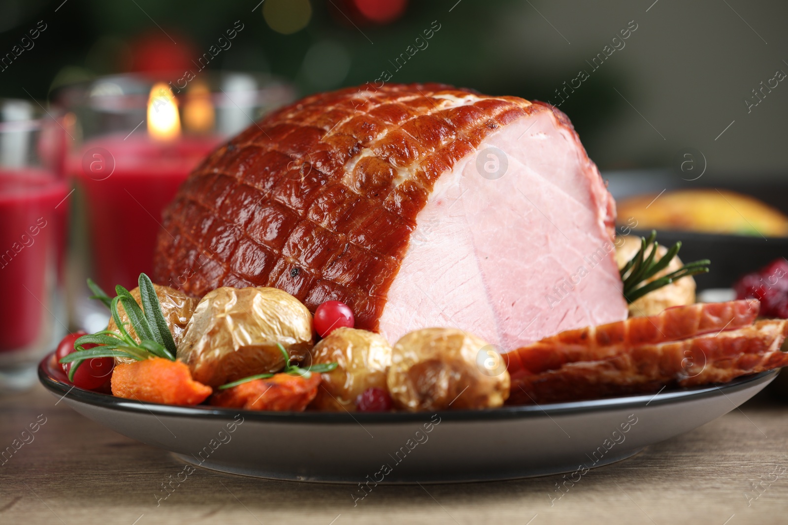 Photo of Christmas food. Tasty baked ham served on wooden table, closeup