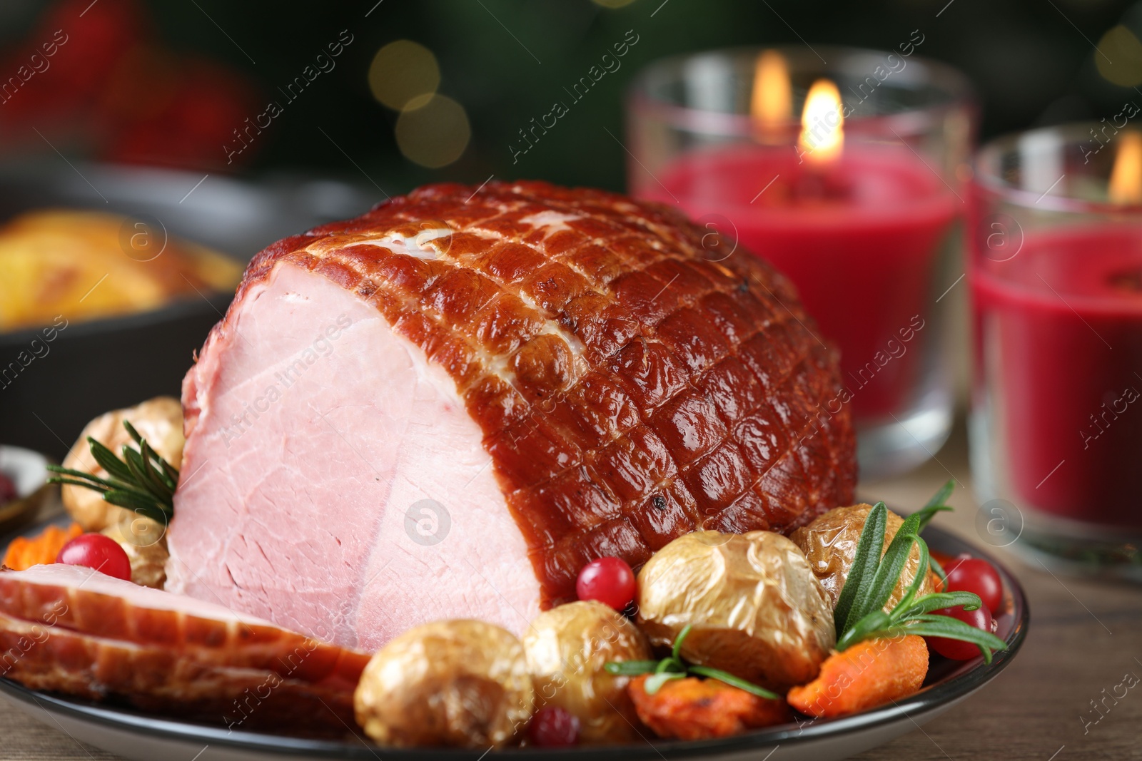 Photo of Christmas food. Tasty baked ham served on wooden table, closeup