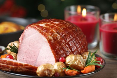 Photo of Christmas food. Tasty baked ham served on wooden table, closeup