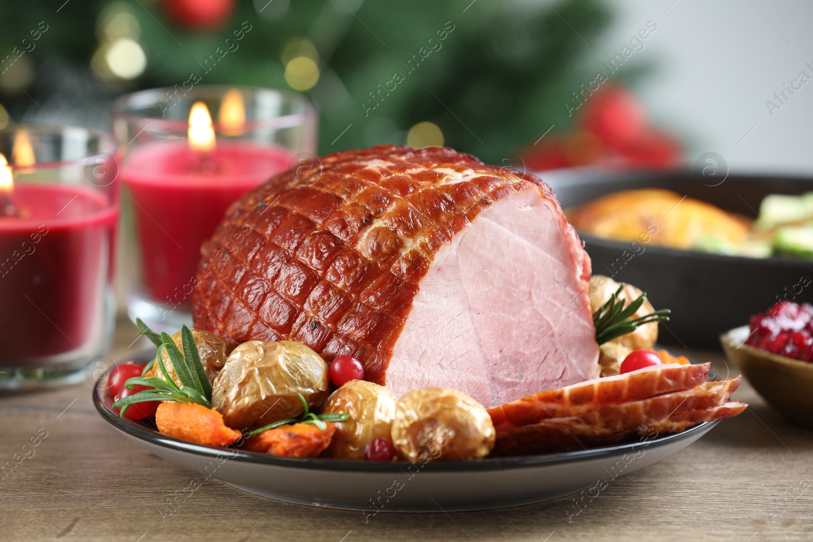 Photo of Christmas food. Tasty baked ham served on wooden table, closeup