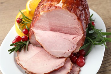 Christmas food. Tasty baked ham served on wooden table, closeup