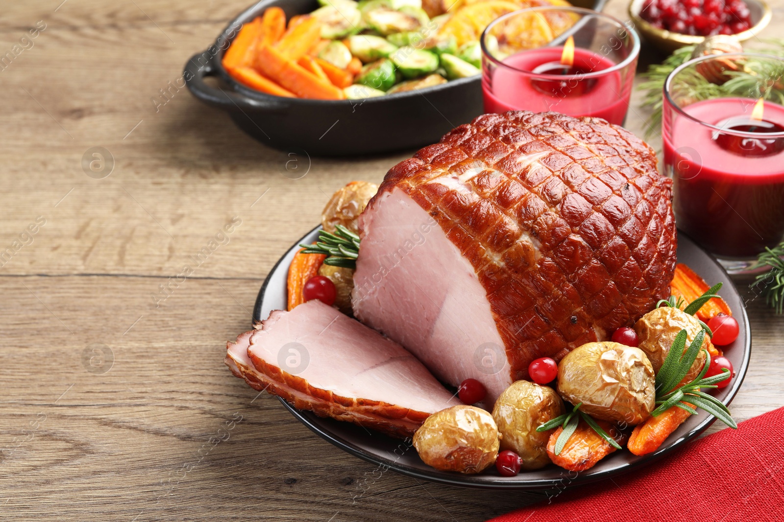 Photo of Christmas food. Tasty baked ham served on wooden table, closeup