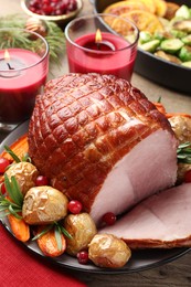 Photo of Christmas food. Tasty baked ham served on wooden table, closeup