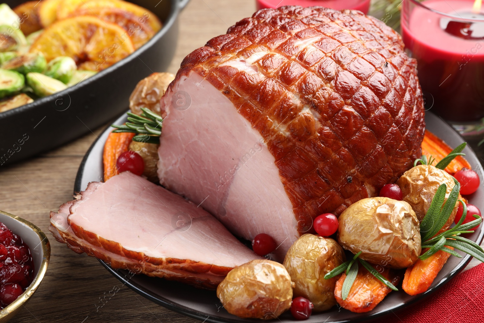 Photo of Christmas food. Tasty baked ham served on wooden table, closeup