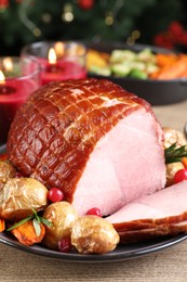 Christmas food. Tasty baked ham served on wooden table, closeup