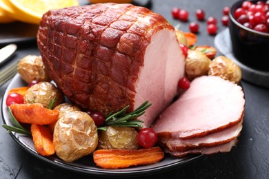 Christmas food. Tasty baked ham served on black table, closeup