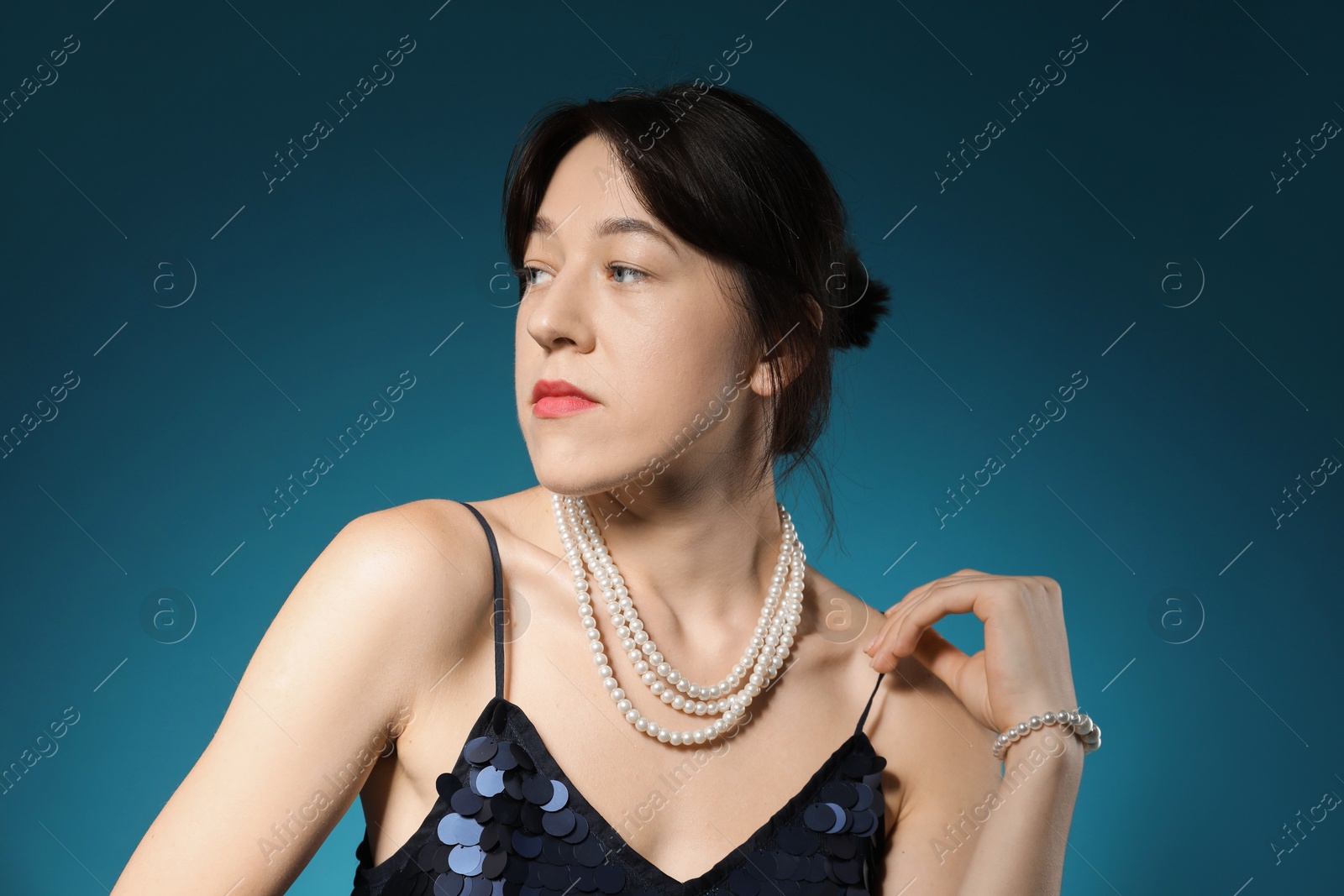 Photo of Portrait of beautiful young woman on blue background