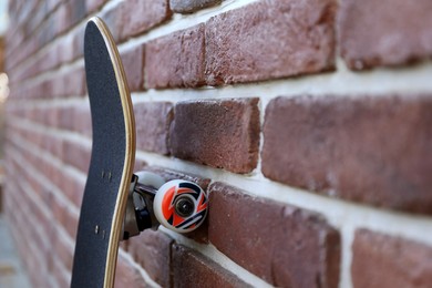 Photo of One skateboard near brick wall outdoors, closeup