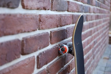 Photo of One skateboard near brick wall outdoors, closeup