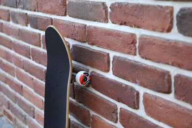 Photo of One skateboard near brick wall outdoors, closeup