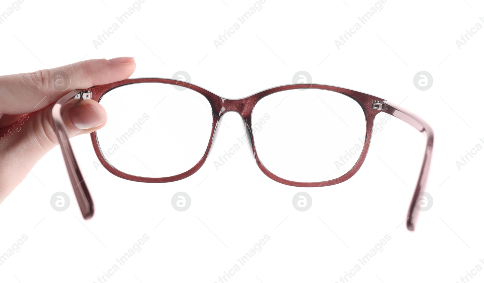 Photo of Woman holding glasses with brown frame on white background, closeup