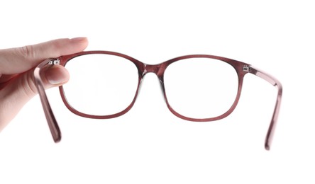 Photo of Woman holding glasses with brown frame on white background, closeup