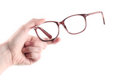 Photo of Woman holding glasses with brown frame on white background, closeup