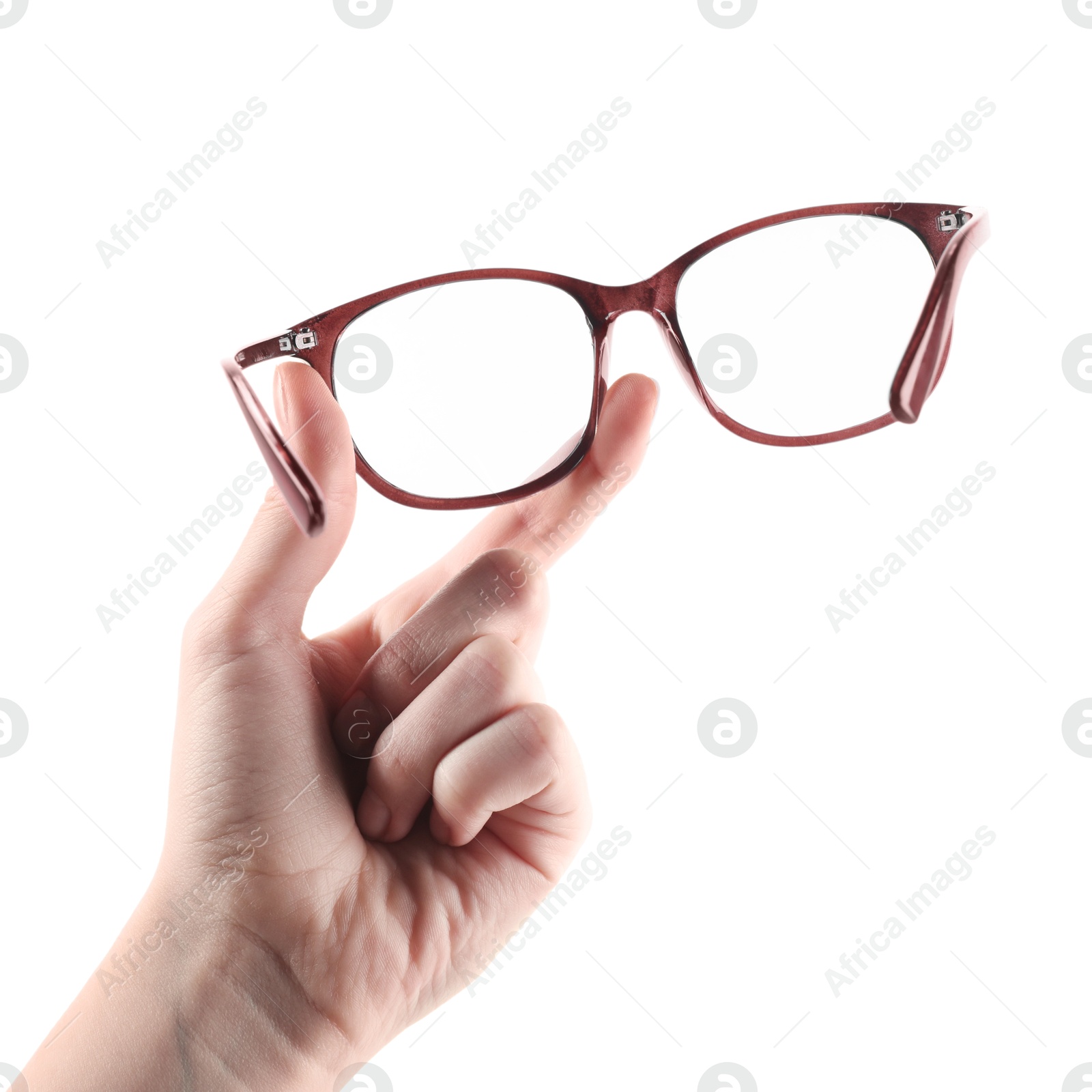 Photo of Woman holding glasses with brown frame on white background, closeup