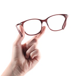 Photo of Woman holding glasses with brown frame on white background, closeup