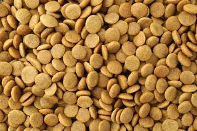 Photo of Pet food granules as background, top view