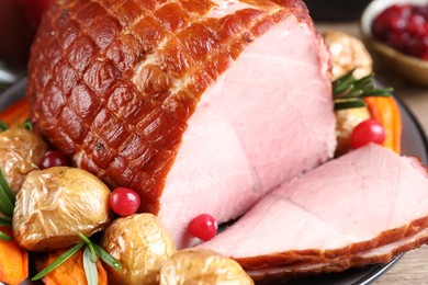 Photo of Christmas food. Tasty baked ham served on table, closeup