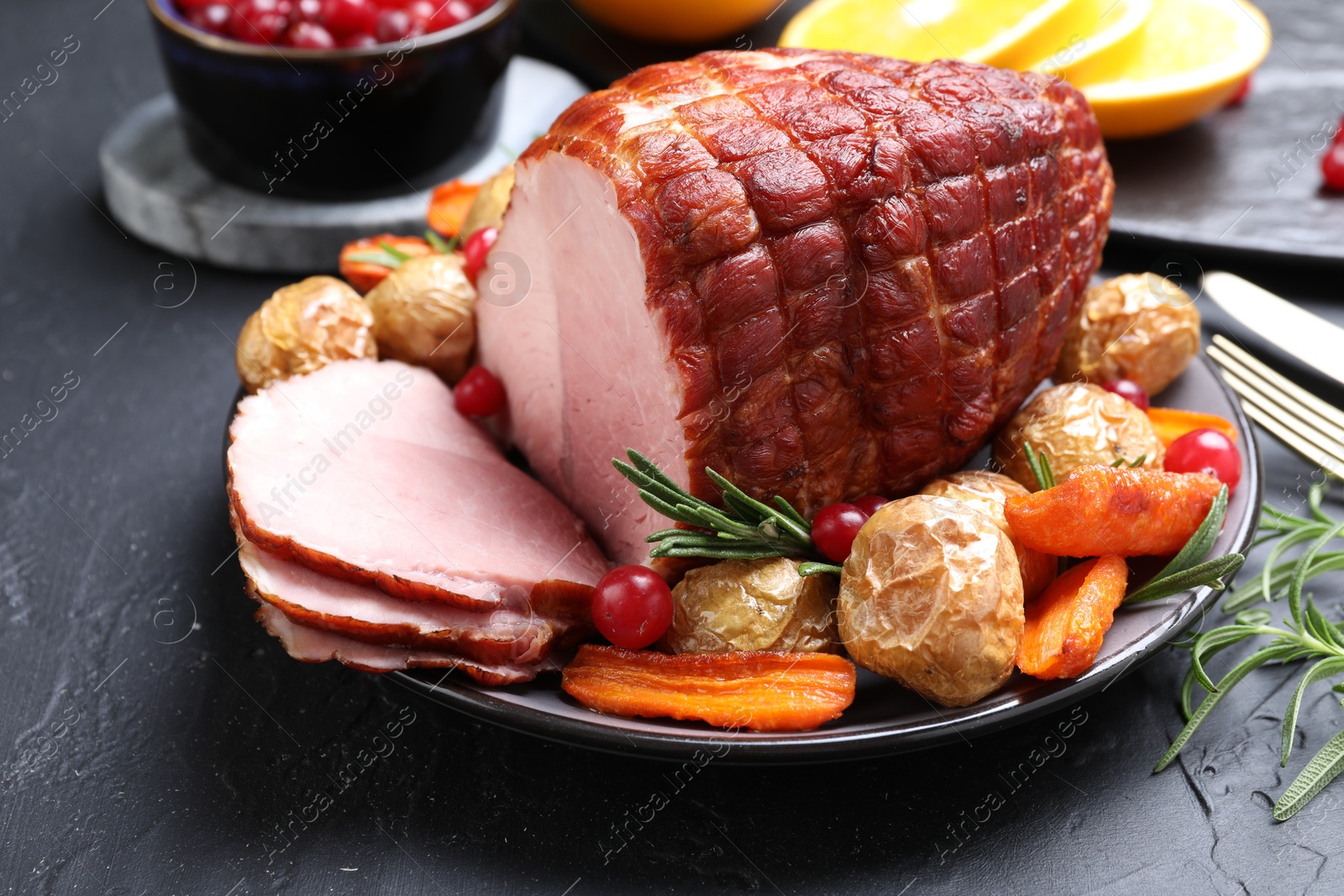 Photo of Christmas food. Tasty baked ham served on black table, closeup