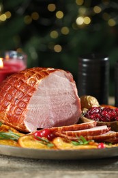 Christmas food. Tasty baked ham served on wooden table, closeup