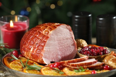 Photo of Christmas food. Tasty baked ham served on wooden table, closeup