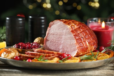 Photo of Christmas food. Tasty baked ham served on wooden table, closeup