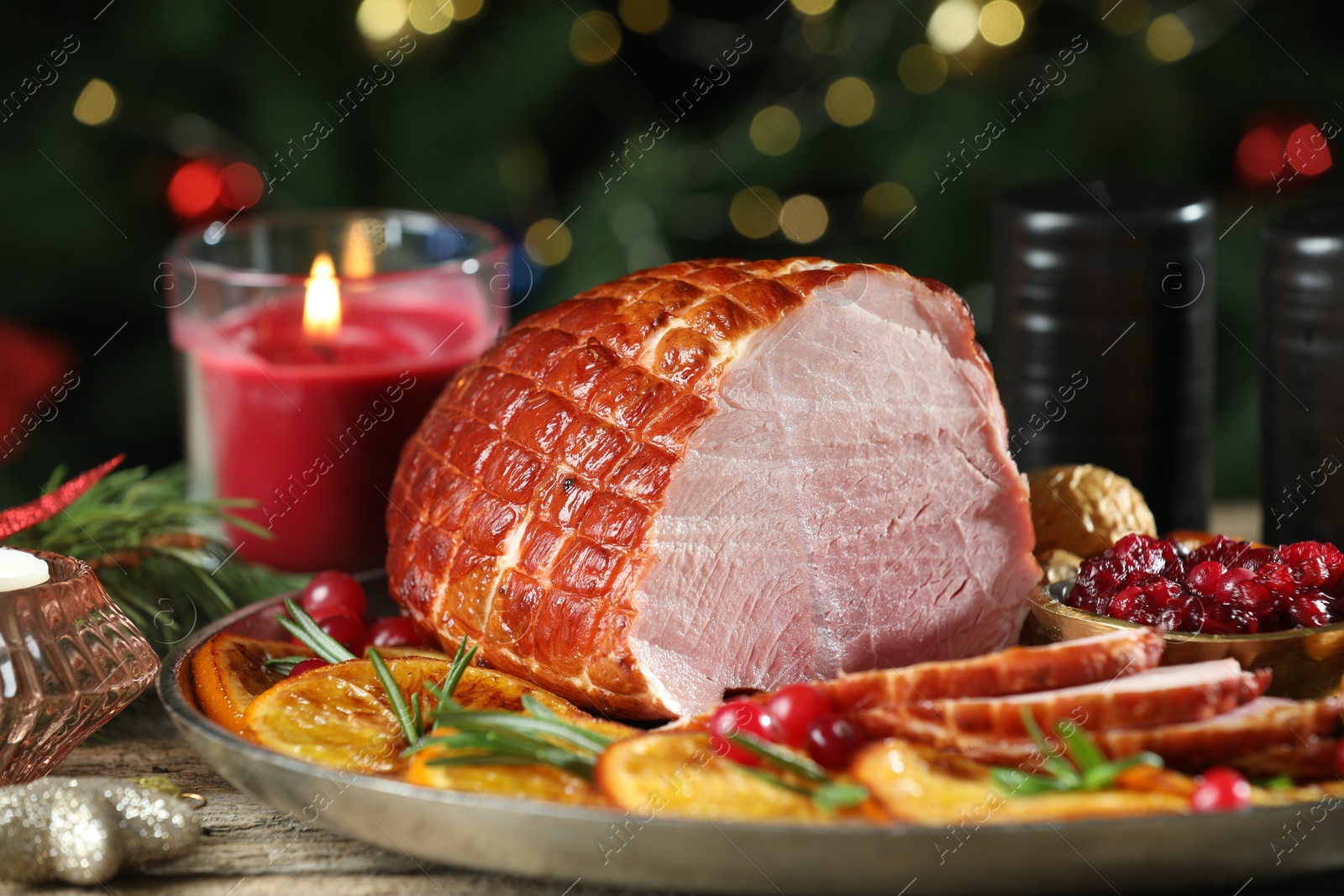 Photo of Christmas food. Tasty baked ham served on wooden table, closeup