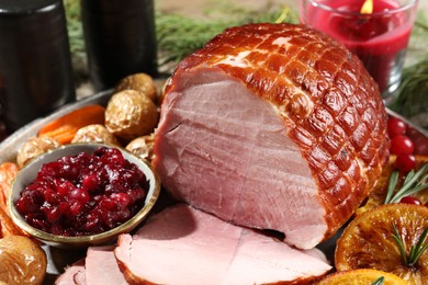 Photo of Christmas food. Tasty baked ham served on table, closeup