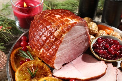 Photo of Christmas food. Tasty baked ham served on wooden table, closeup