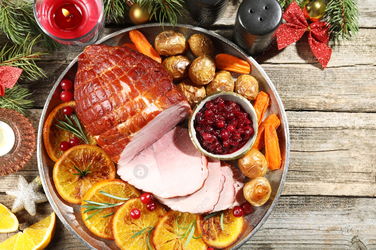 Photo of Christmas food. Tasty baked ham served on wooden table, flat lay