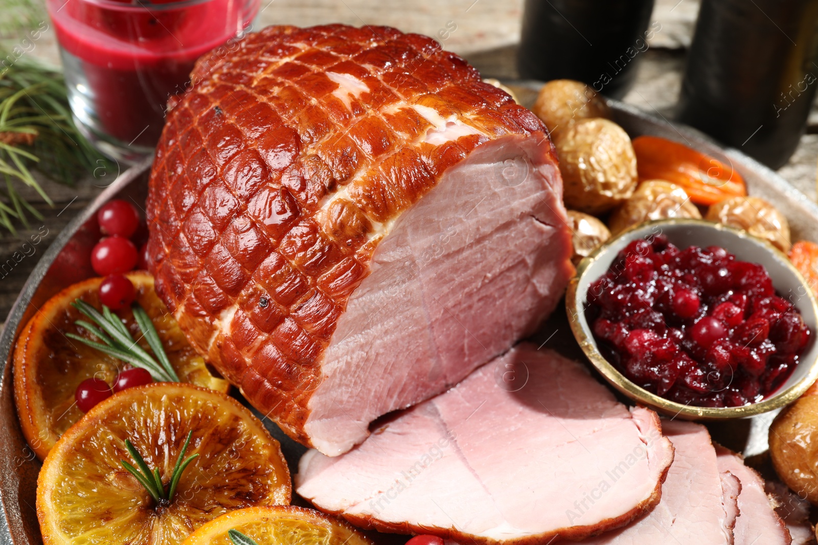 Photo of Christmas food. Tasty baked ham served on table, closeup