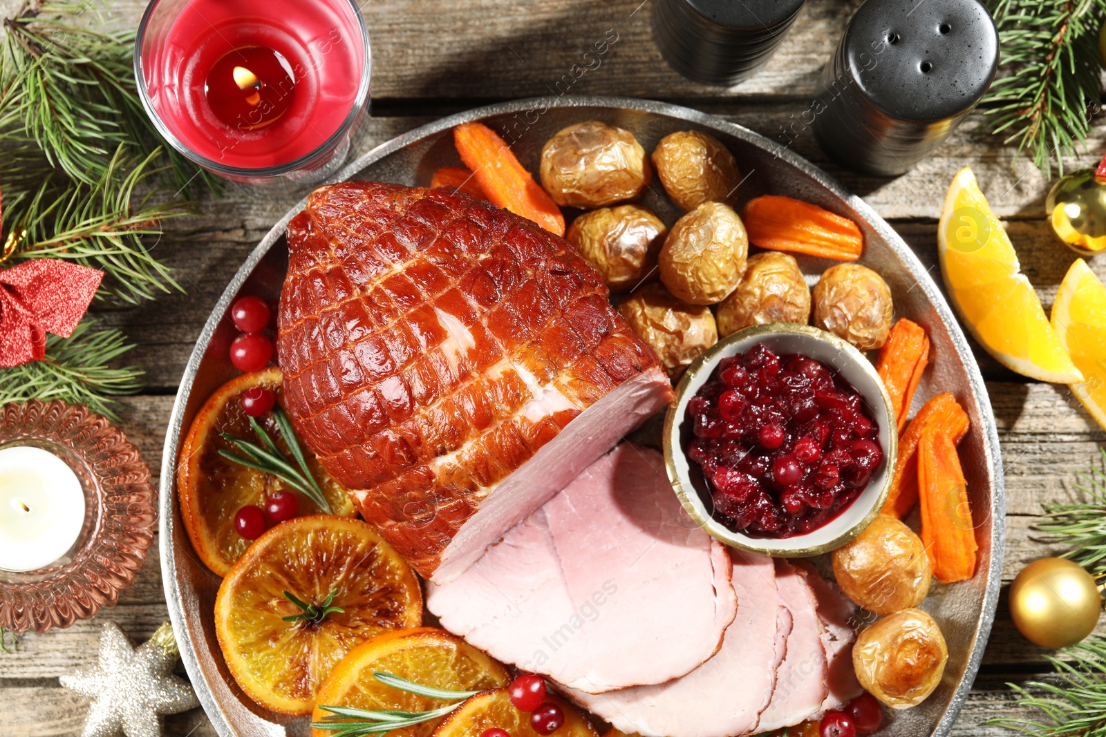 Photo of Christmas food. Tasty baked ham served on wooden table, flat lay