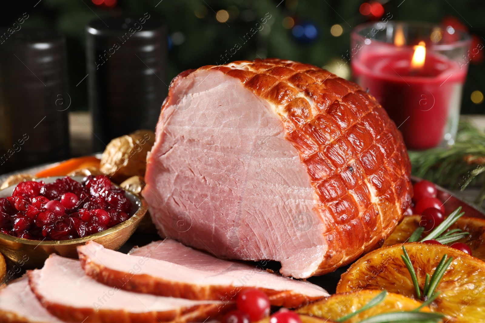 Photo of Christmas food. Tasty baked ham served on table, closeup