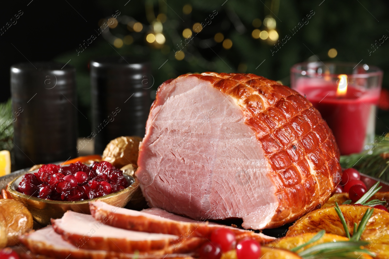 Photo of Christmas food. Tasty baked ham served on table, closeup