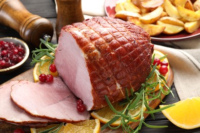 Photo of Christmas food. Tasty baked ham served on table, closeup