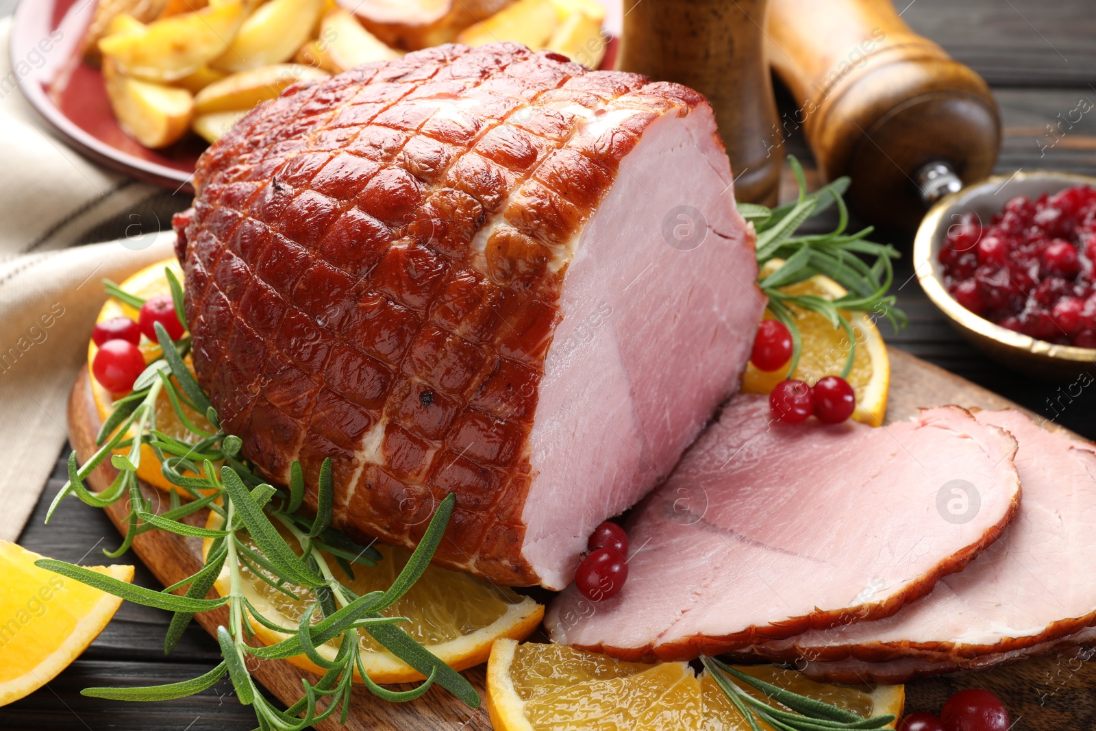 Photo of Christmas food. Tasty baked ham served on wooden table, closeup