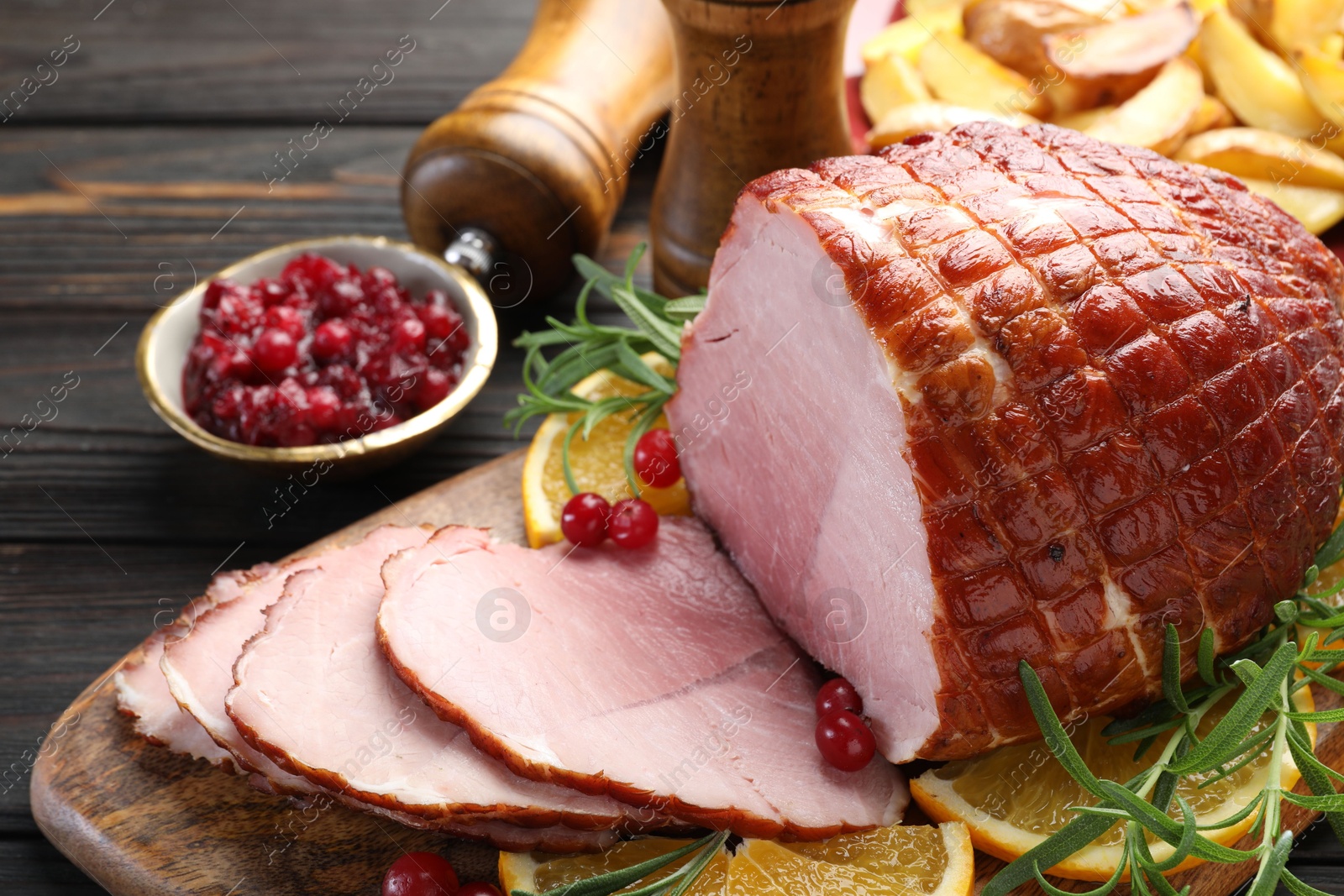 Photo of Christmas food. Tasty baked ham served on wooden table, closeup