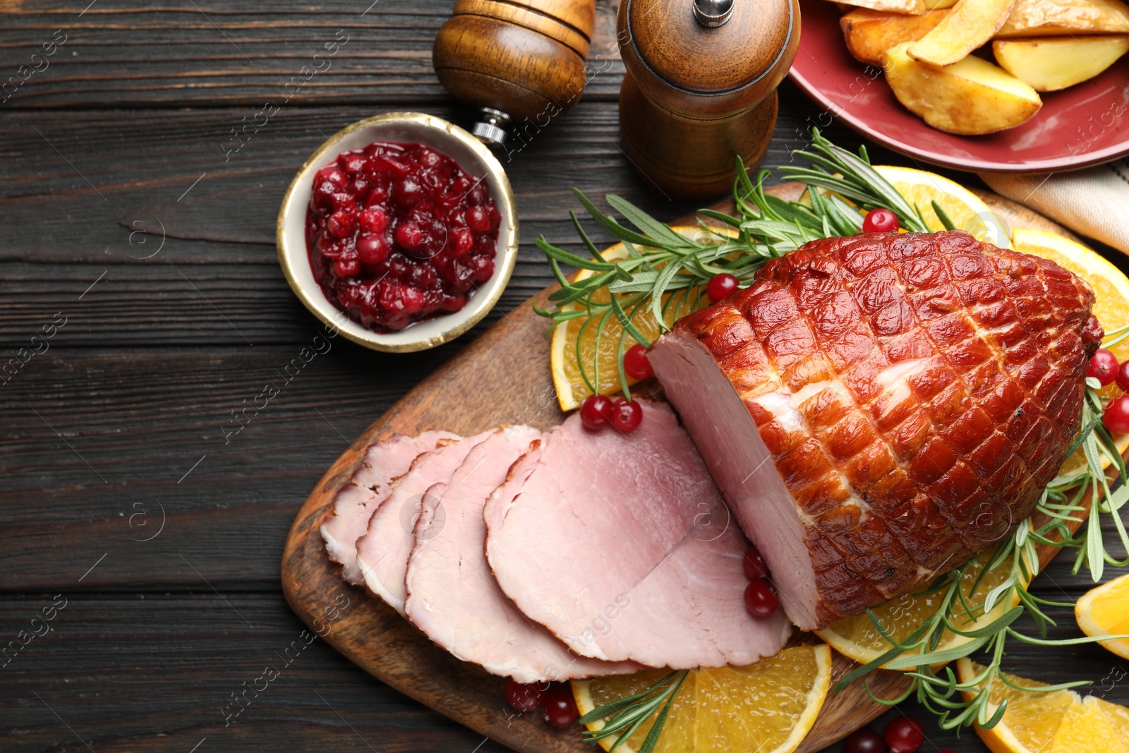 Photo of Christmas food. Tasty baked ham served on wooden table, flat lay