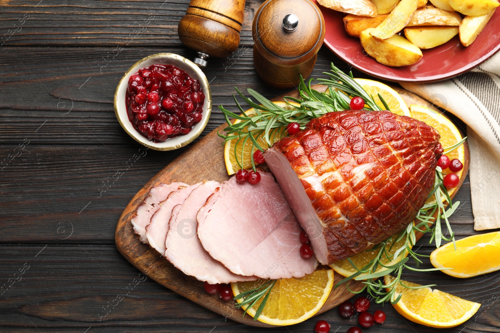 Photo of Christmas food. Tasty baked ham served on wooden table, flat lay