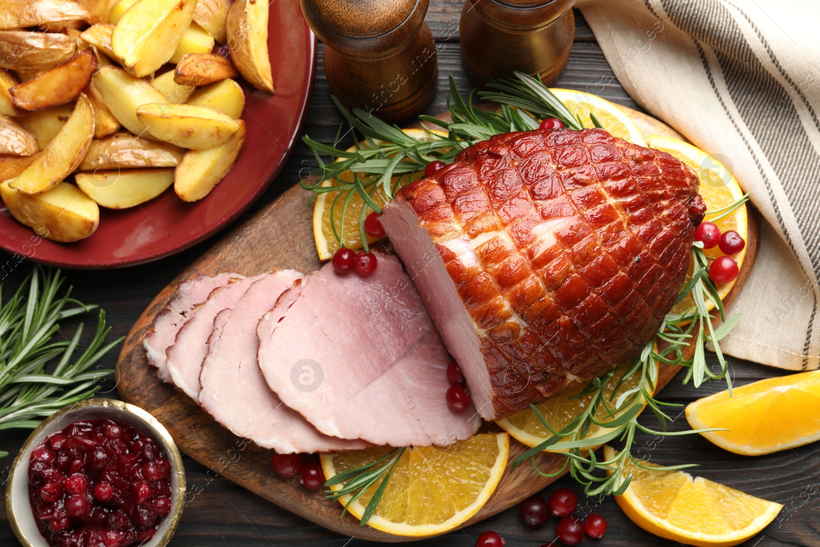 Photo of Christmas food. Tasty baked ham served on wooden table, flat lay