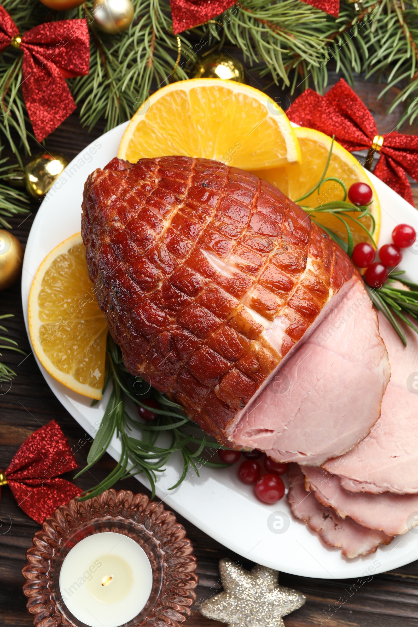 Photo of Christmas food. Tasty baked ham served on wooden table, flat lay