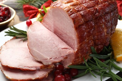 Photo of Christmas food. Tasty baked ham served on table, closeup