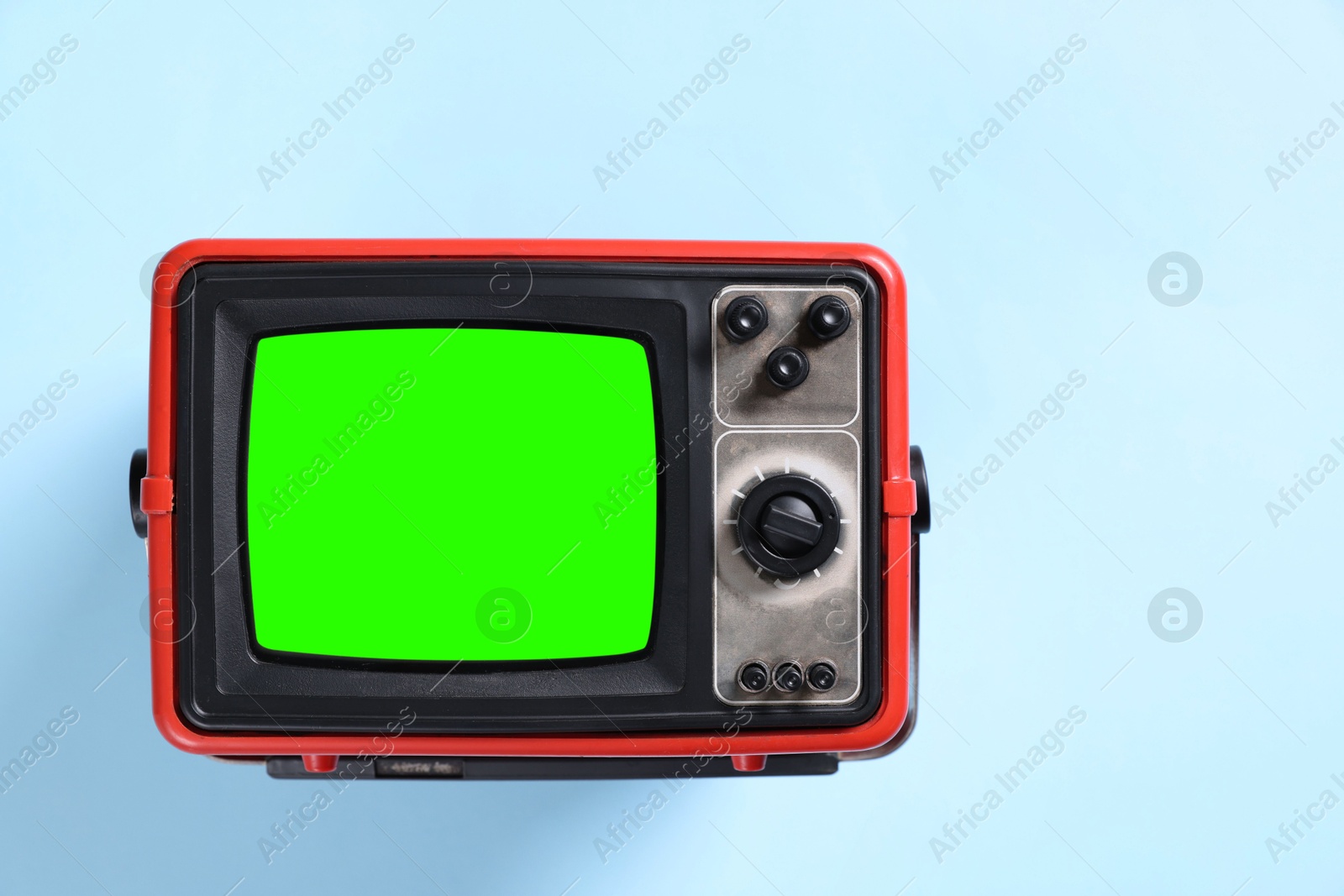 Image of Retro Tv set with green screen on light blue background, space for design. Chroma key