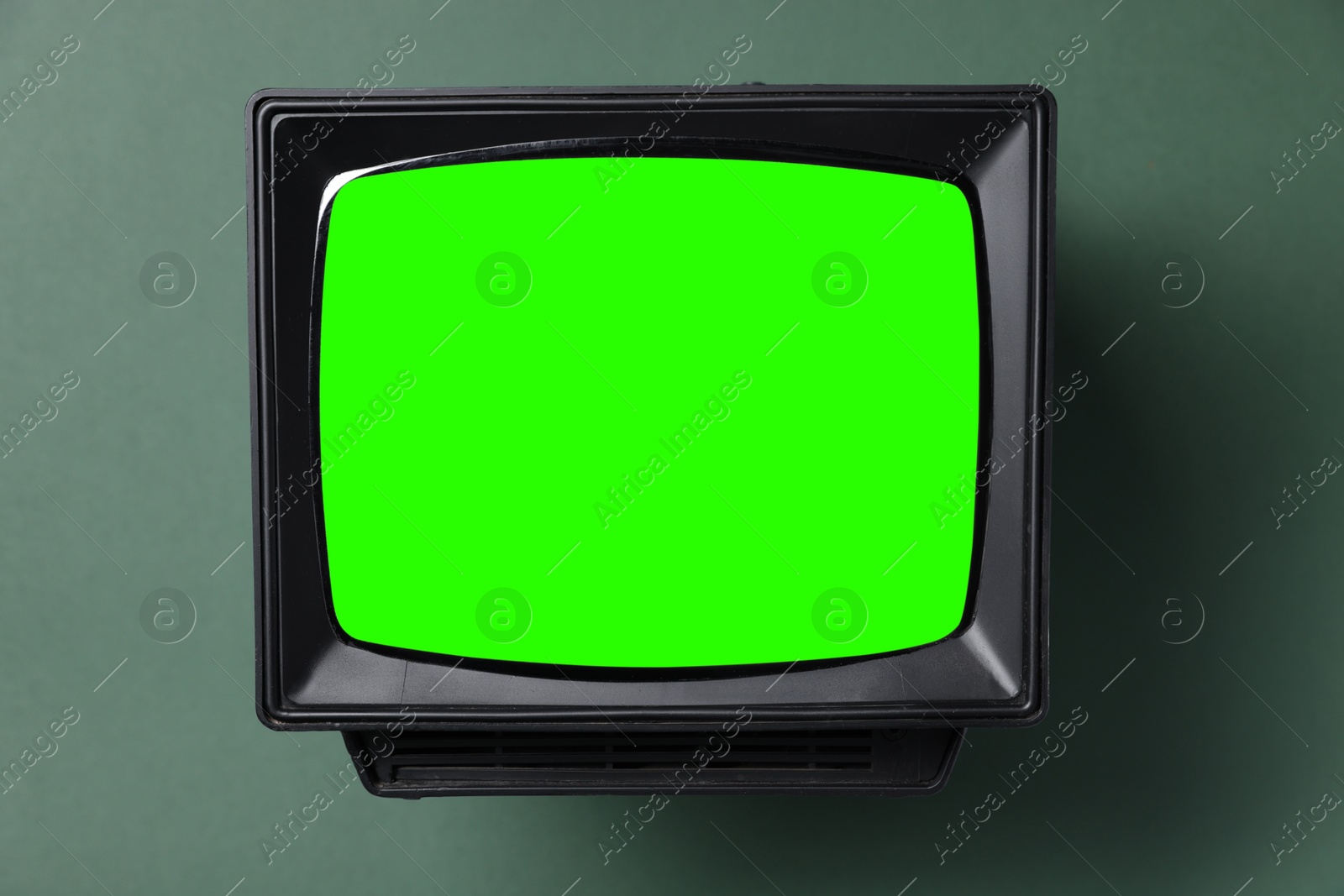 Image of Retro Tv set with green screen on color background. Chroma key