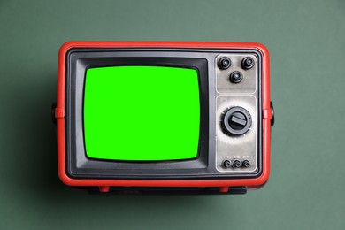 Image of Retro Tv set with green screen on color background. Chroma key